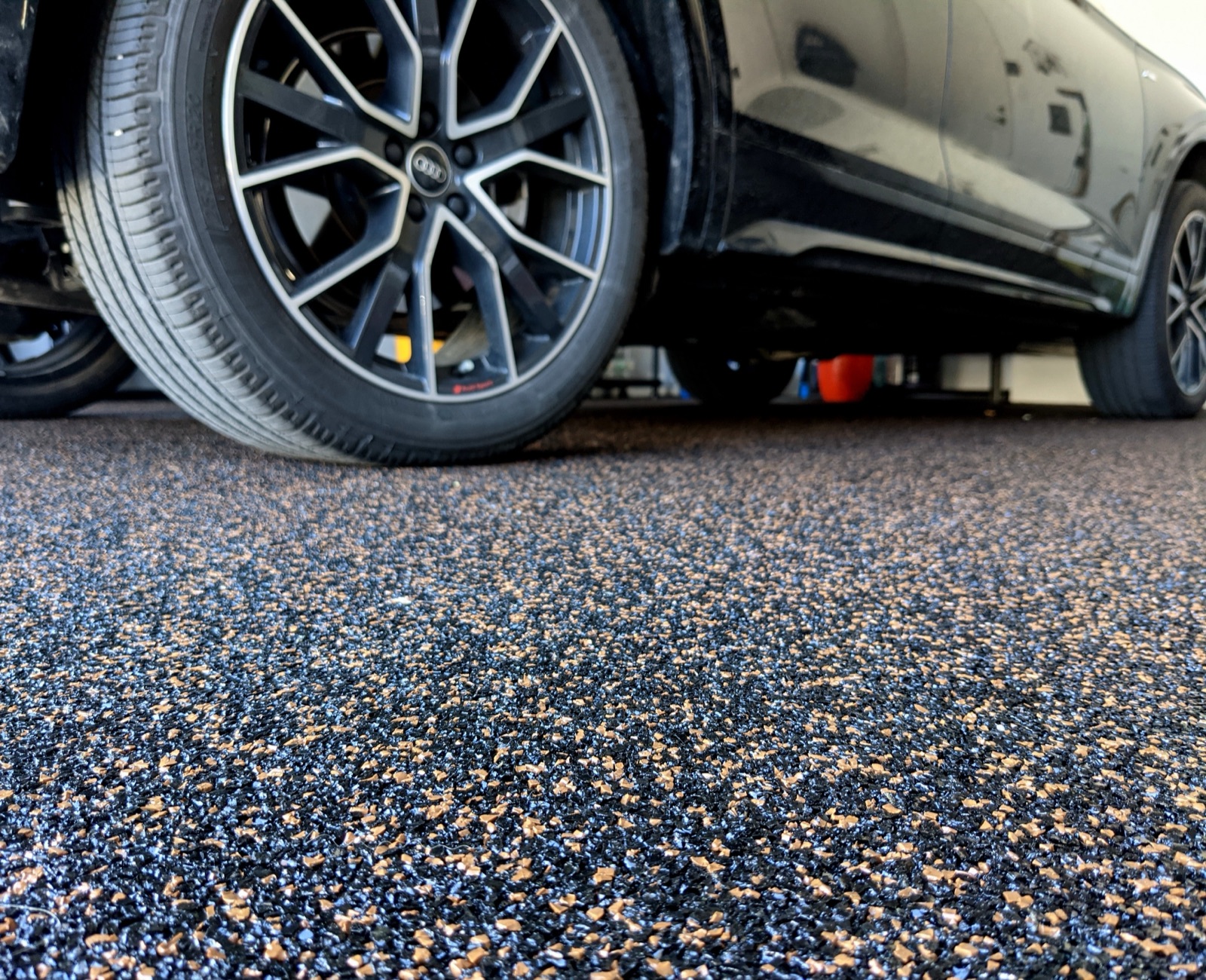 Close-up of resin-bound aggregate under a car wheel