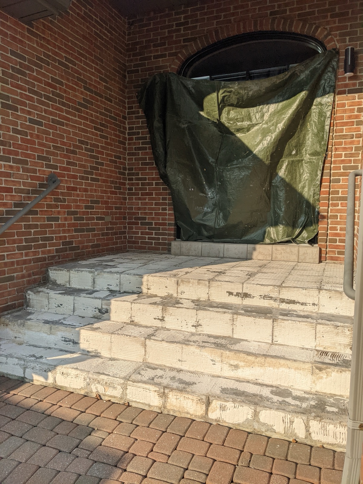 Arched double-door entry before grey resin — before