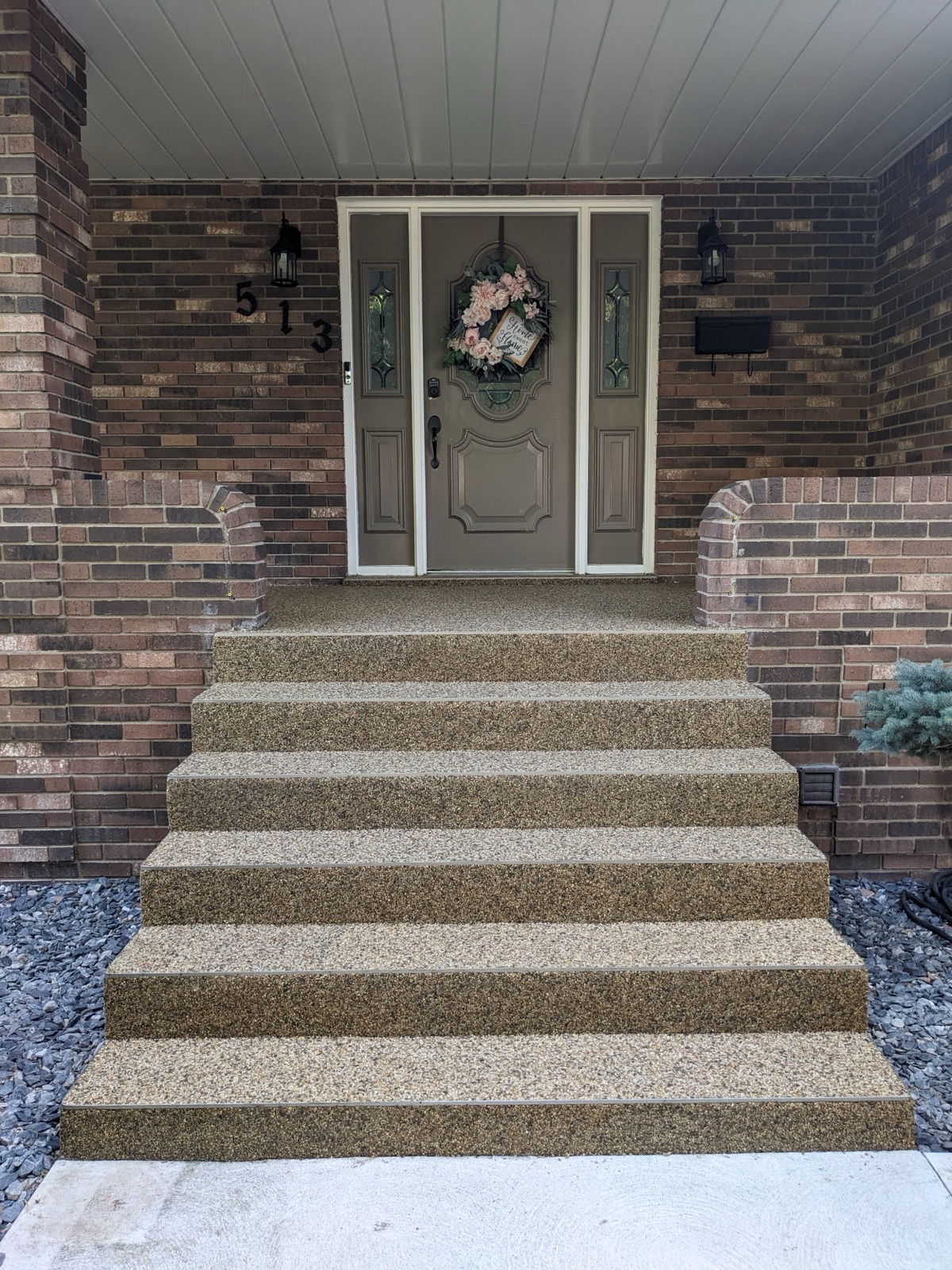 Tan resin patio at a brick house — after
