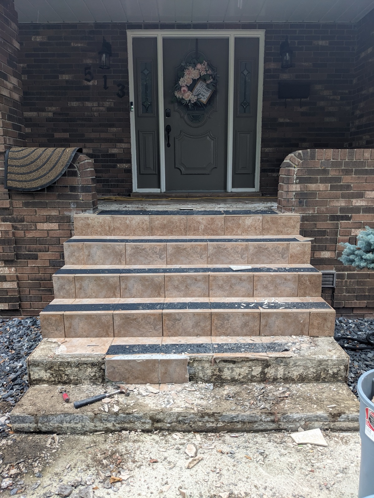 Brick house patio before tan resin resurfacing — before
