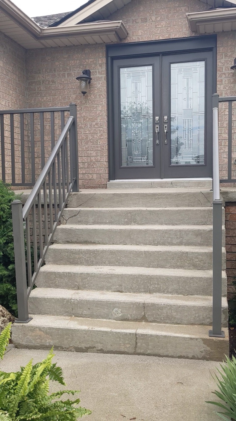 Double-door entrance before tan resin resurfacing — before