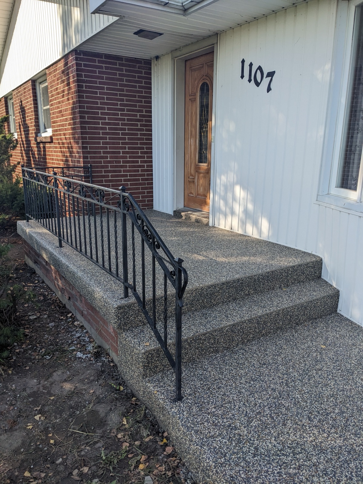 Grey resin steps with handrail — after