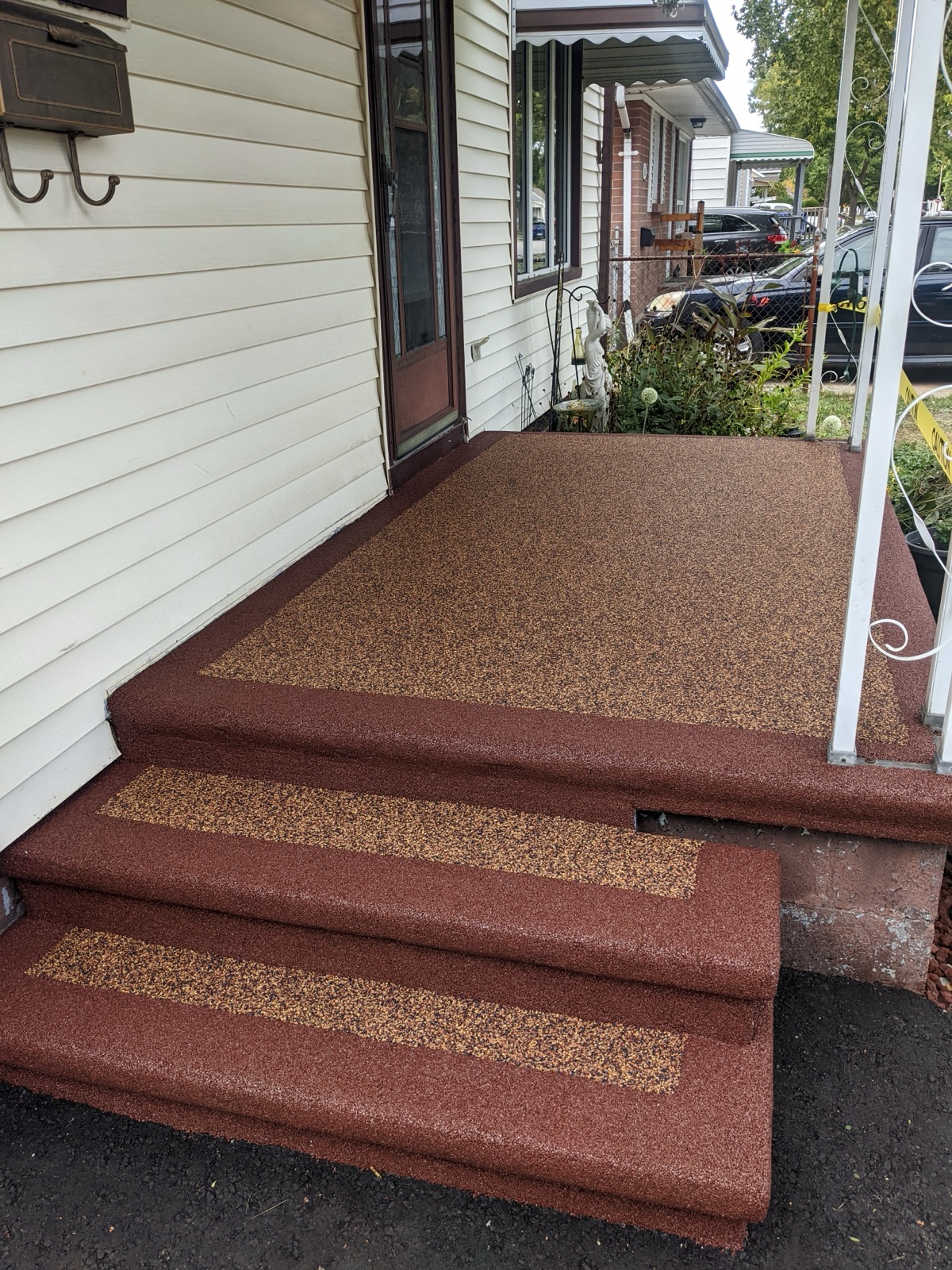 Red poured rubber steps at a front entry — after