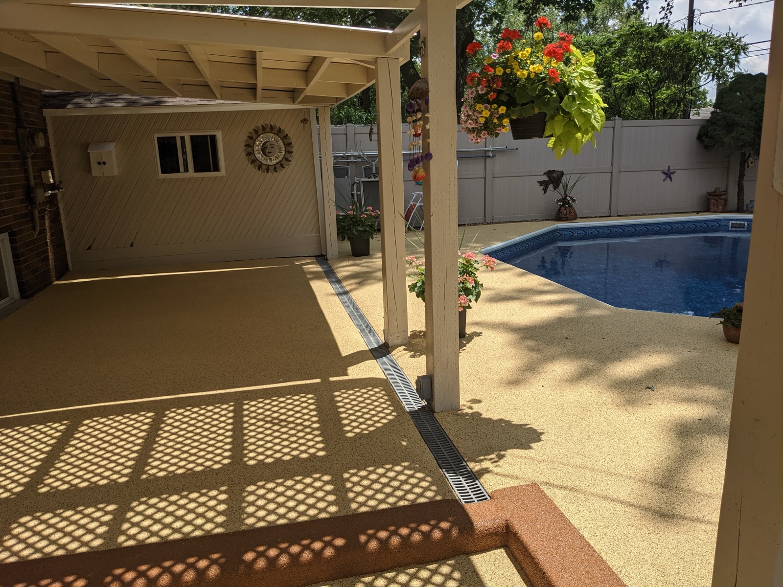 Pool deck with brown border and drain detail — after