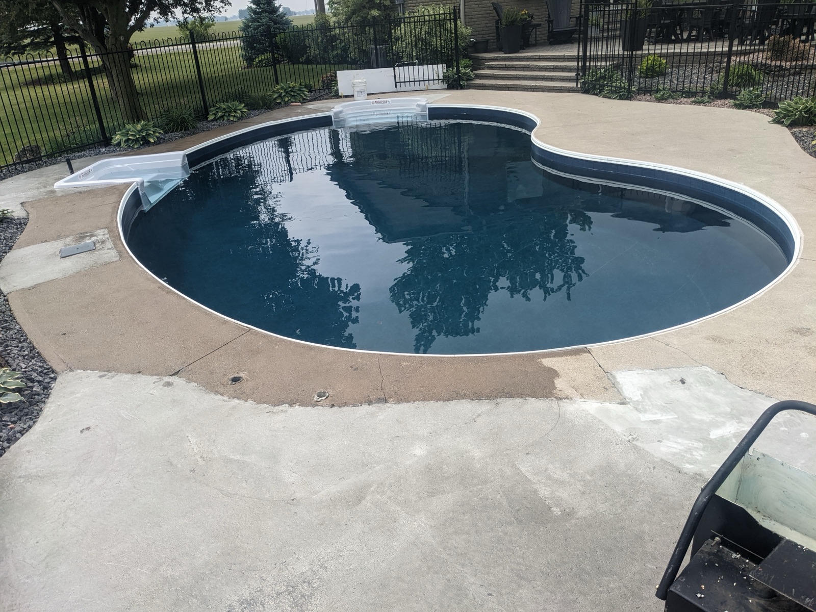 Pool deck before dark grey resin resurfacing — before