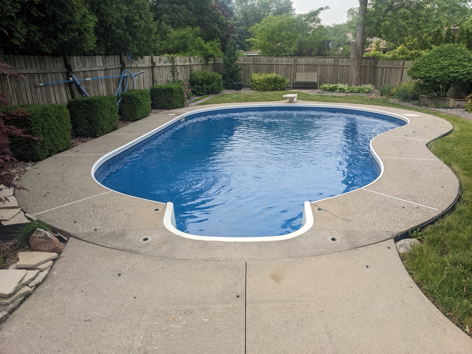 Pool deck before tan resin with red maple — before