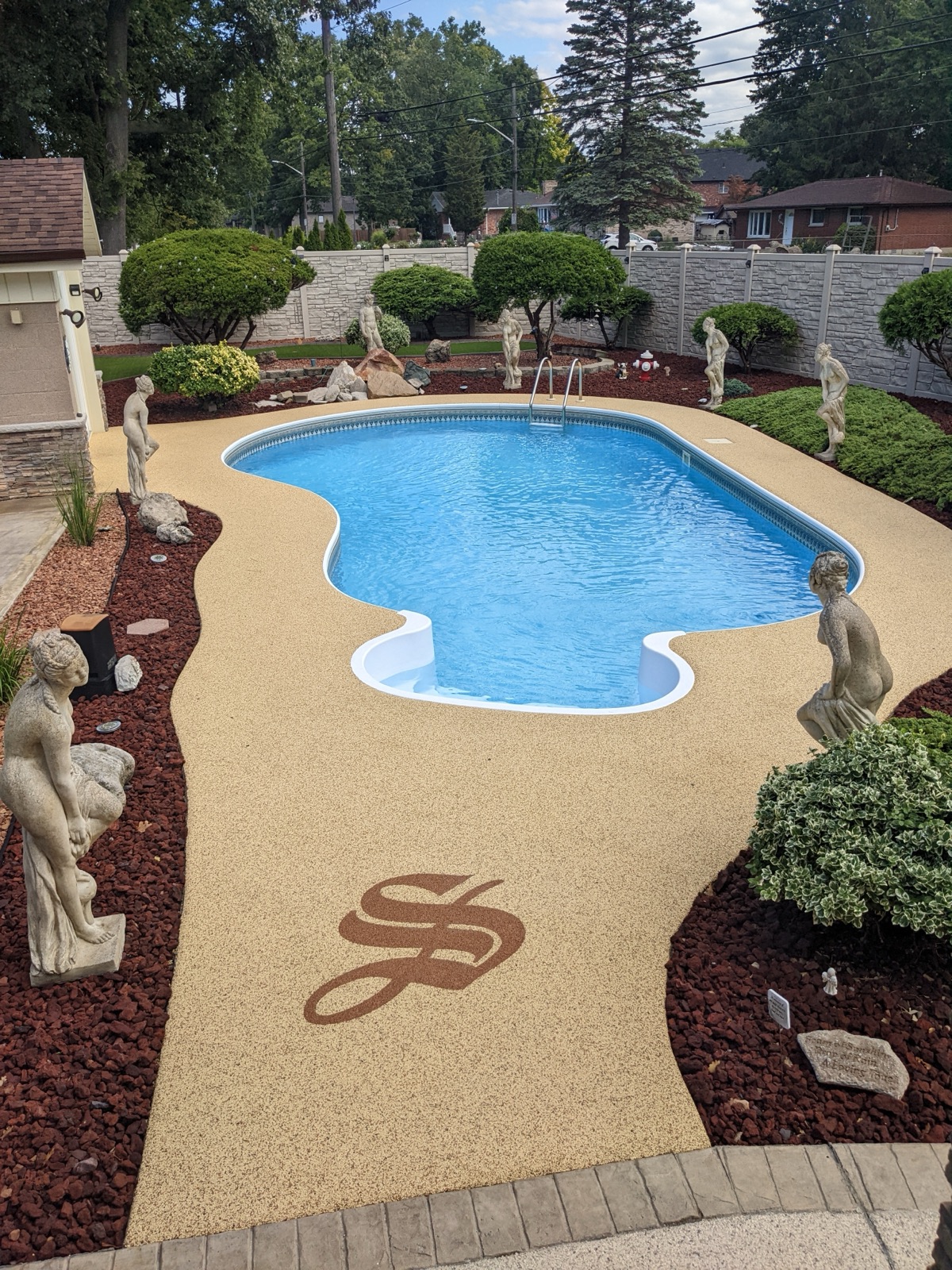 Pool deck with Stone-it-Up logo inlay — after