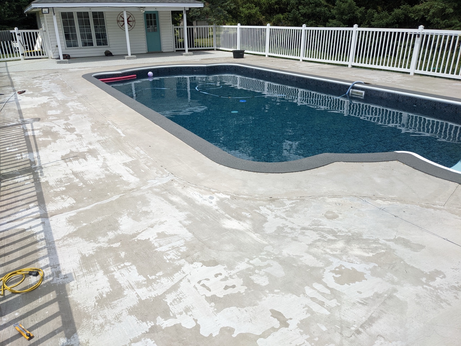 Pool deck before grey resin with slat fence — before