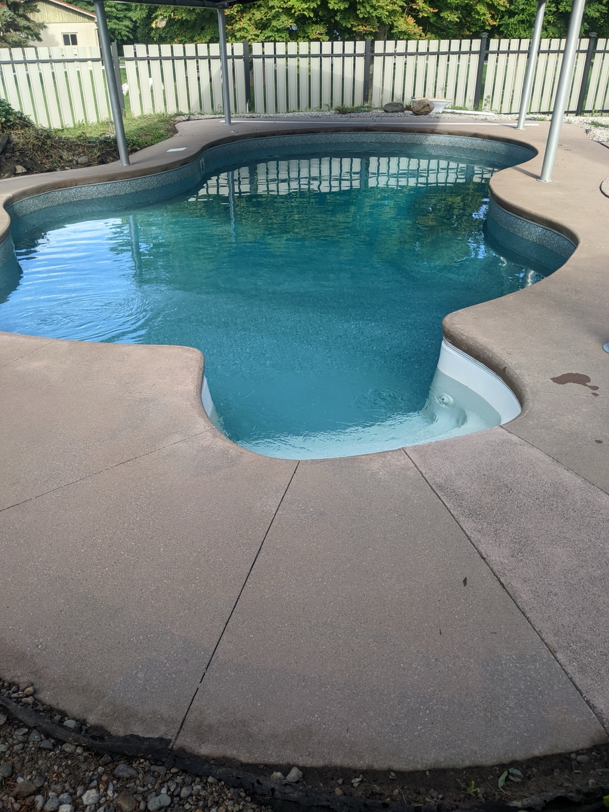 Pool deck before grey resin with slat fence alternate — before