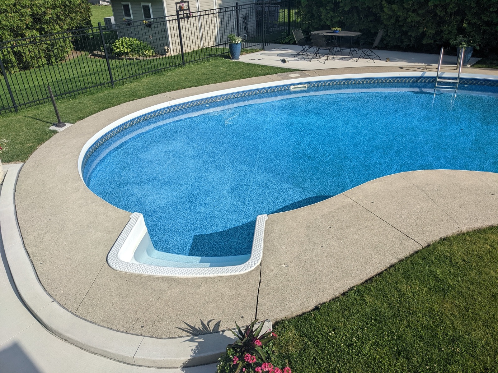 Pool deck before grey resin with white fence — before