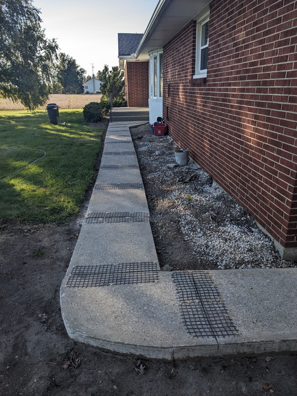 Narrow walkway with mesh before resurfacing — before